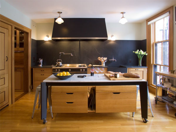 Modern restaurant style kitchen with expansive Vermont soapstone backsplash