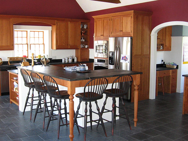 A Vermont Soapstone floor is light blue-gray with subtle veining, which compliments the oiled soapstone countertops.