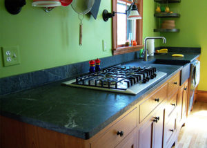 Vermont Soapstone kitchen countertop with built-in cooktop and apron-front sink