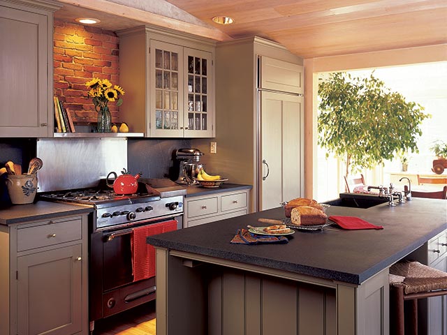 This lovely kitchen features a huge island cut from a single piece of Vermont Soapstone.