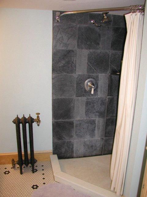 Vermont Soapstone tiles in the shower are elegant and impervious to water.
