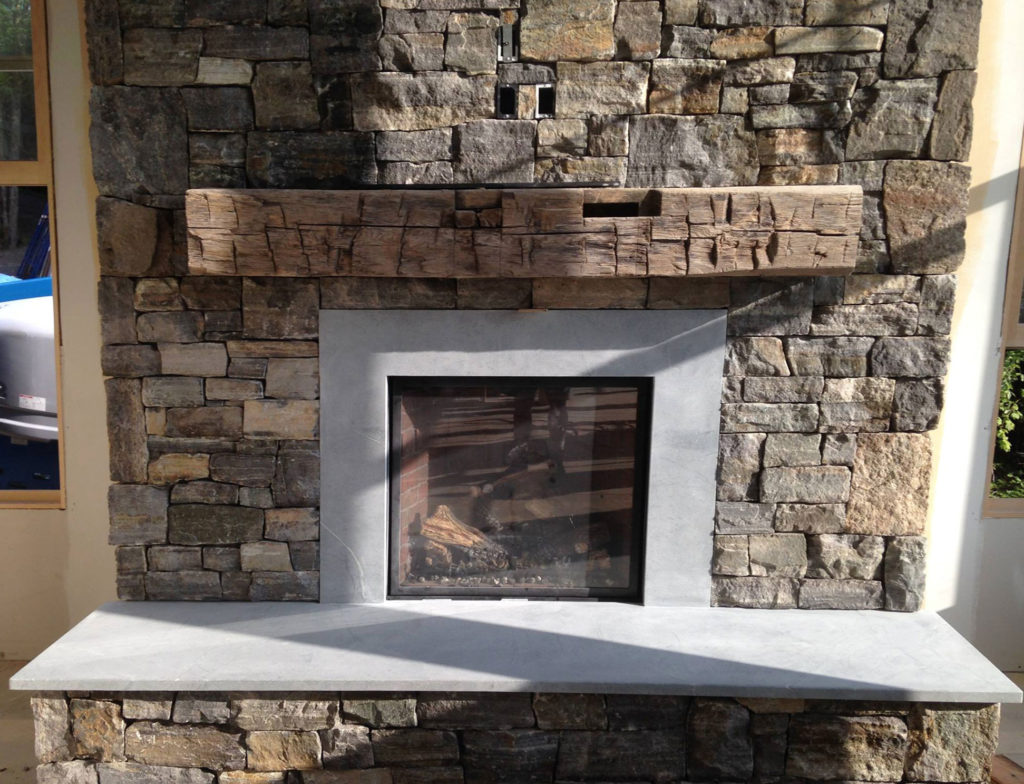 Vermont Soapstone provided the custom cut stone for this fireplace insert and hearth.