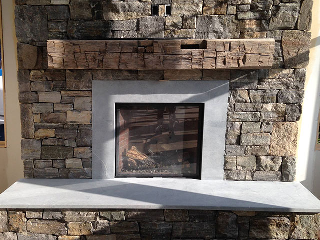 Vermont Soapstone provided the custom cut stone for this fireplace insert and hearth.