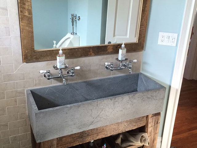 Unique extra-wide Vermont Soapstone lavatory fits perfectly in this rustic bathroom.