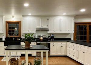 Expansive farmhouse style kitchen with countertops and sink installed by Vermont Soapstone craftsmen.