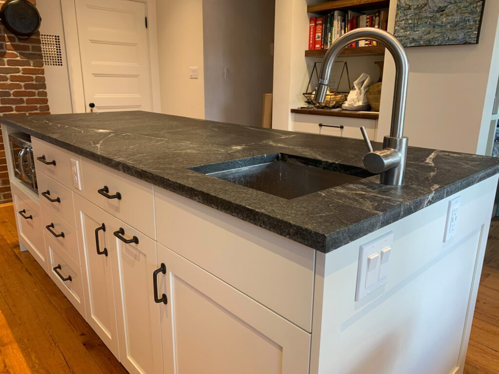 Soapstone kitchen island with undermount stainless sink.
