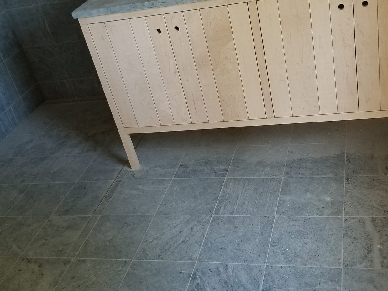 Modern bathroom design with Vermont Soapstone tiled walls and flooring.