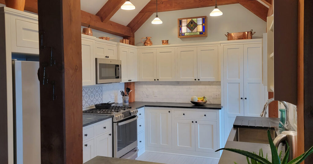 Expansive farmhouse style kitchen with countertops and sink installed by Vermont Soapstone craftsmen.