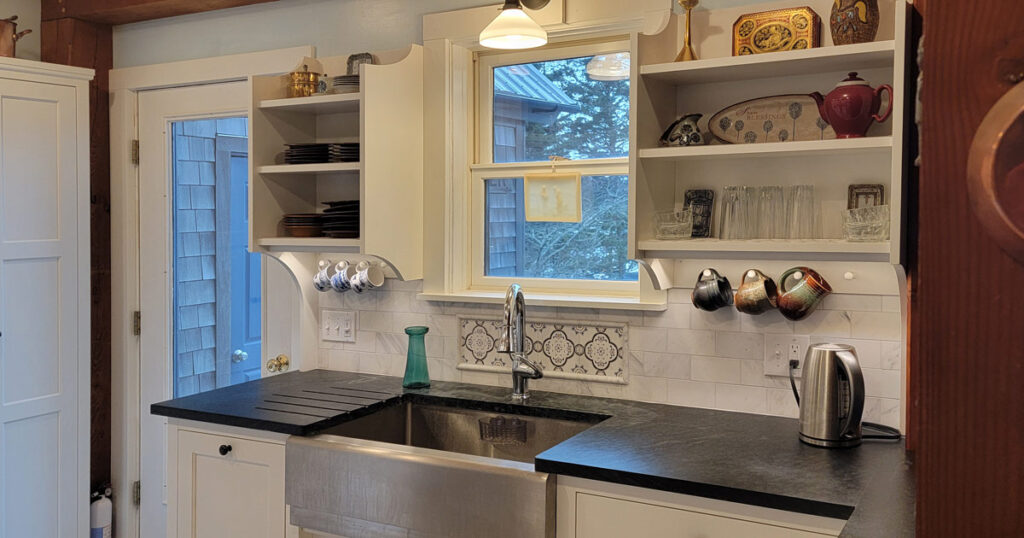 Expansive farmhouse style kitchen with countertops and sink installed by Vermont Soapstone craftsmen.